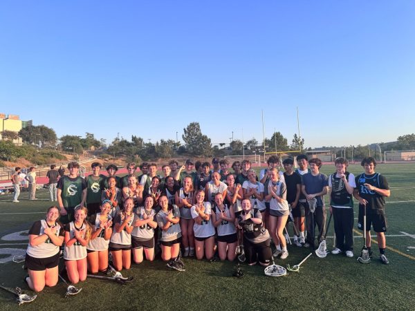 Boys and Girls pose for a picture. Boys are holding L's while Girls are holding W's. Photo courtesy of Sandy Ahearn.